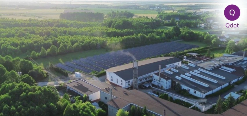  Industrial facility with solar panels surrounded by greenery representing ISO 14001 environmental management and sustainable industry 